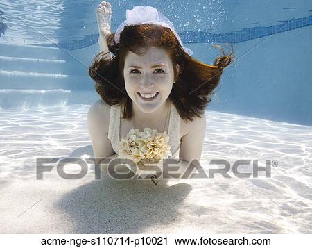 USA, Utah, Orem, Portrait of young bride with bouquet under water View Large Photo Image Stock Image - USA, Utah, Orem, Portrait of young bride with bouquet under water. Fotosearch