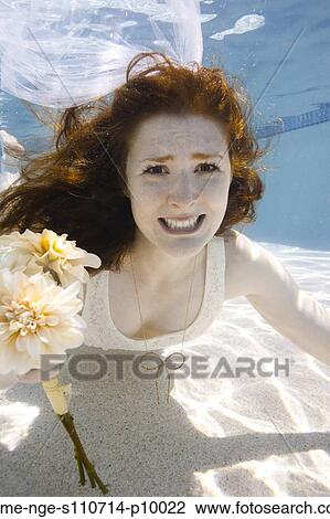 USA, Utah, Orem, Portrait of young bride with bouquet under water View Large Photo Image Stock Image - USA, Utah, Orem, Portrait of young bride with bouquet under water. Fotosearch