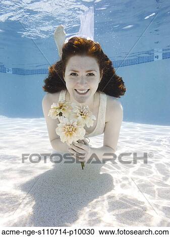 USA, Utah, Orem, Portrait of young woman with bouquet under water View Large Photo Image Stock Image - USA, Utah, Orem, Portrait of young woman with bouquet under water. Fotosearch