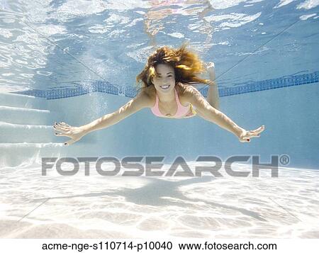 Stock Image - USA, Utah, Orem, Portrait of young woman under water. Fotosearch