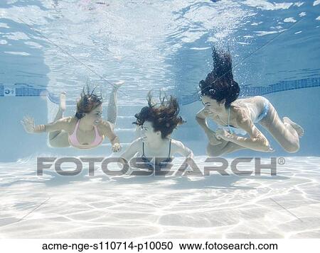 Stock Image - USA, Utah, Orem, Portrait of young women under water. Fotosearch