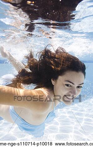 Stock Photo - USA, Utah, Orem, Portrait of young woman under water. Fotosearch