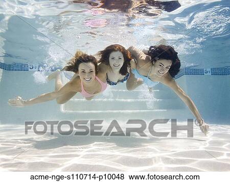 Stock Photo - USA, Utah, Orem, Portrait of young women under water. Fotosearch
