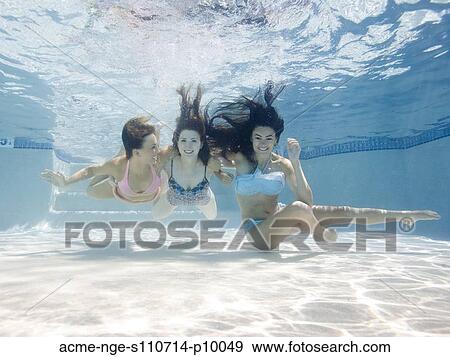 Stock Photo - USA, Utah, Orem, Portrait of young women under water. Fotosearch