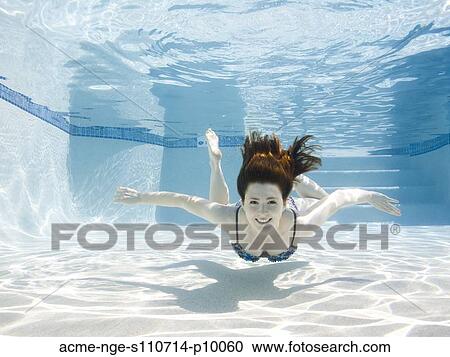 USA, Utah, Orem, Smiling woman swimming in swimming pool View Large Photo Image Stock Image - USA, Utah, Orem, Smiling woman swimming in swimming pool. Fotosearch