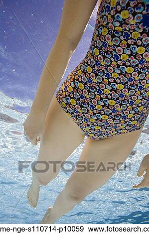 USA, Utah, Orem, Woman in floral swimwear in swimming pool View Large Photo Image Stock Photo - USA, Utah, Orem, Woman in floral swimwear in swimming pool. Fotosearch