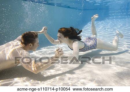 Picture - USA, Utah, Orem, Young couple under water. Fotosearch