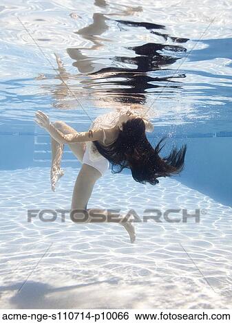 USA, Utah, Orem, Young woman in pool ballet dancing View Large Photo Image Stock Photograph - USA, Utah, Orem, Young woman in pool ballet dancing. Fotosearch