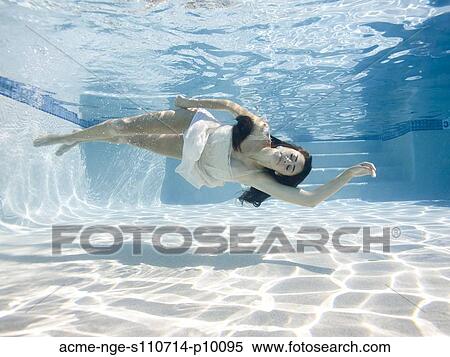 Stock Photography - USA, Utah, Orem, Young woman in pool ballet dancing. Fotosearch