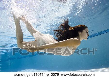 USA, Utah, Orem, Young woman swimming in swimming pool View Large Photo Image Stock Photo - USA, Utah, Orem, Young woman swimming in swimming pool. Fotosearch
