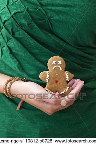 Woman's hand holding sad gingerbread man View Large Photo Image Stock Photo - Woman's hand holding sad gingerbread man. Fotosearch