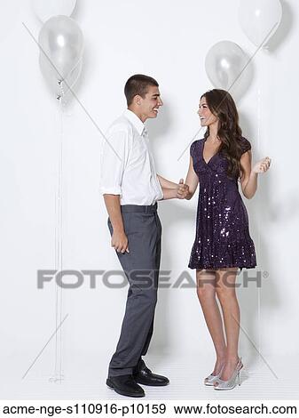Stock Photo - Young couple flirting at party. Fotosearch