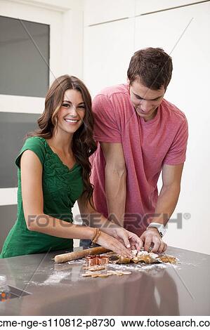 Young couple preparing gingerbread cookies View Large Photo Image Stock Image - Young couple preparing gingerbread cookies. Fotosearch