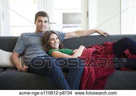 Young couple sofa resting on sofa View Large Photo Image Picture - Young couple sofa resting on sofa. Fotosearch