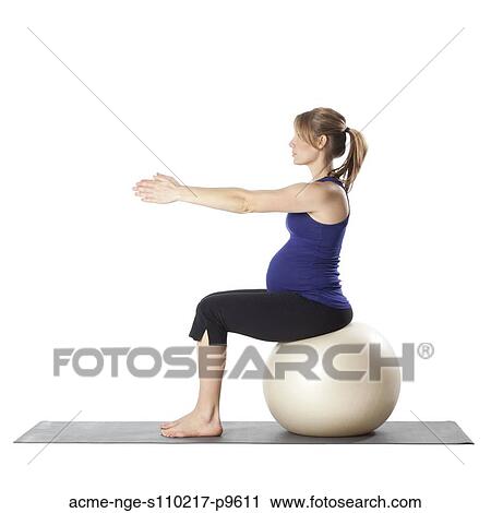 Young pregnant woman exercising on fitness ball, studio shot View Large Photo Image Stock Image - Young pregnant woman exercising on fitness ball, studio shot. Fotosearch