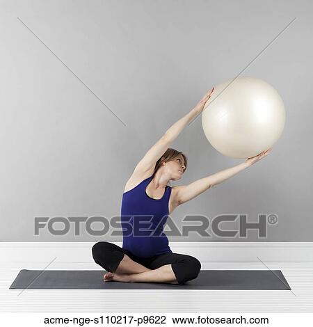 Young pregnant woman exercising with fitness ball, studio shot View Large Photo Image Stock Image - Young pregnant woman exercising with fitness ball, studio shot. Fotosearch