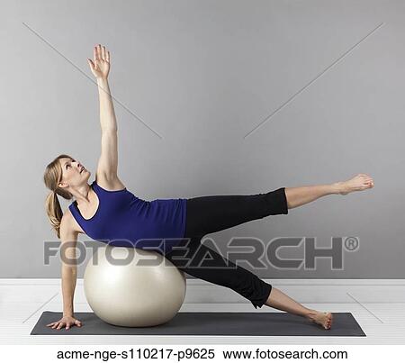Young pregnant woman exercising with fitness ball, studio shot View Large Photo Image Stock Photography - Young pregnant woman exercising with fitness ball, studio shot. Fotosearch