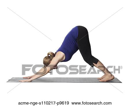 Stock Photo - Young pregnant woman practicing yoga, studio shot. Fotosearch