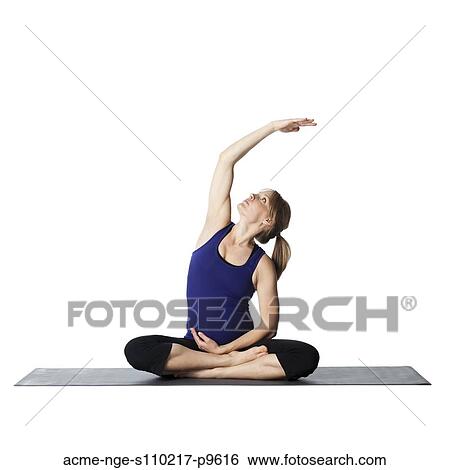 Stock Photograph - Young pregnant woman practicing yoga, studio shot. Fotosearch