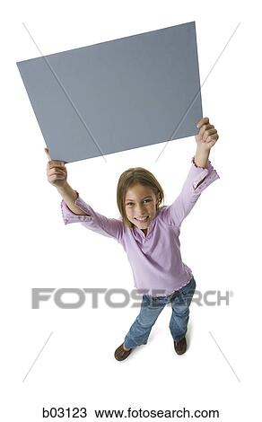 High angle view of a girl holding a blank sign View Large Photo Image Stock Image - High angle view of a girl holding a blank sign. Fotosearch