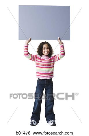 Portrait of a girl holding a blank sign up of her head View Large Photo Image Stock Photograph - Portrait of a girl holding a blank sign up of her head. Fotosearch