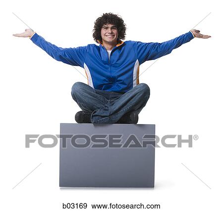 Portrait of a teenage boy sitting on a blank sign View Large Photo Image Stock Photo - Portrait of a teenage boy sitting on a blank sign. Fotosearch
