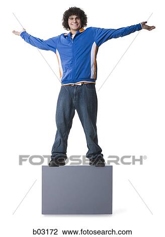 Stock Image - Portrait of a teenage boy standing on a blank sign and smiling. Fotosearch