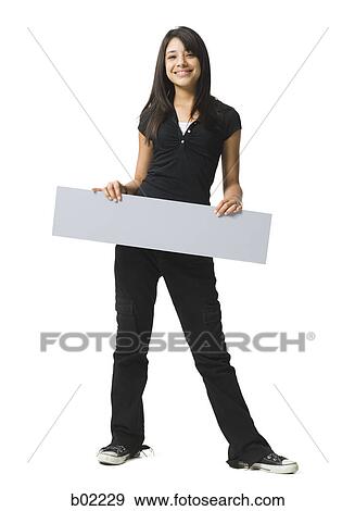Portrait of a teenage girl holding a blank sign View Large Photo Image Stock Photo - Portrait of a teenage girl holding a blank sign. Fotosearch