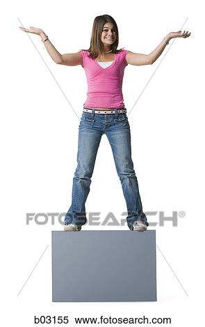 Stock Photography - Portrait of a teenage girl standing on a blank sign. Fotosearch