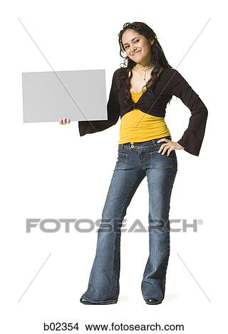 Portrait of a young woman holding a blank sign View Large Photo Image Picture - Portrait of a young woman holding a blank sign. Fotosearch