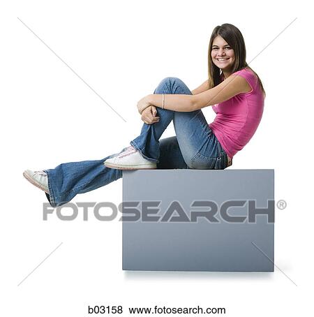 Stock Photo - Profile of a teenage girl relaxing on a blank sign and smiling. Fotosearch