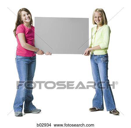 Two young girls holding a blank sign View Large Photo Image Picture - Two young girls holding a blank sign. Fotosearch