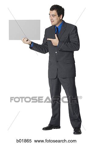 Businessman holding a blank sign View Large Photo Image Stock Photography - Businessman holding a blank sign. Fotosearch