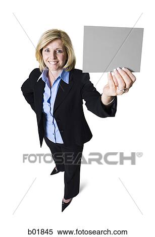 High angle view of a businesswoman holding a blank sign View Large Photo Image Stock Photography - High angle view of a businesswoman holding a blank sign. Fotosearch