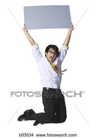 Low angle view of a young woman operating a personal organizer View Large Photo Image Picture - Low angle view of a young woman operating a personal organizer. Fotosearch