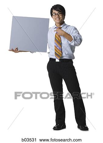 Portrait of a businessman holding and pointing to a compact disc View Large Photo Image Stock Image - Portrait of a businessman holding and pointing to a compact disc. Fotosearch