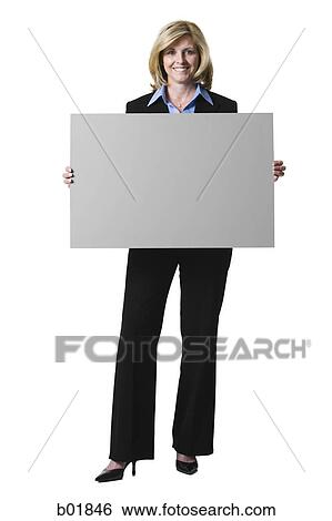 Stock Photograph - Portrait of a businesswoman holding a blank sign. Fotosearch