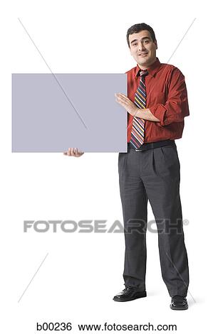 Portrait of a mature man holding a placard View Large Photo Image Stock Photograph - Portrait of a mature man holding a placard. Fotosearch