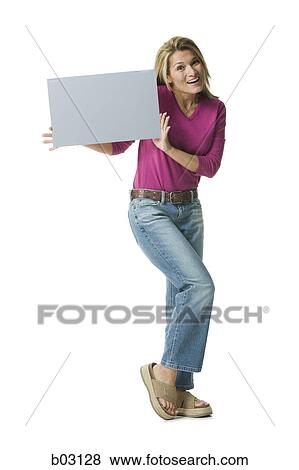 Portrait of a mid adult woman holding a blank sign View Large Photo Image Stock Photo - Portrait of a mid adult woman holding a blank sign. Fotosearch