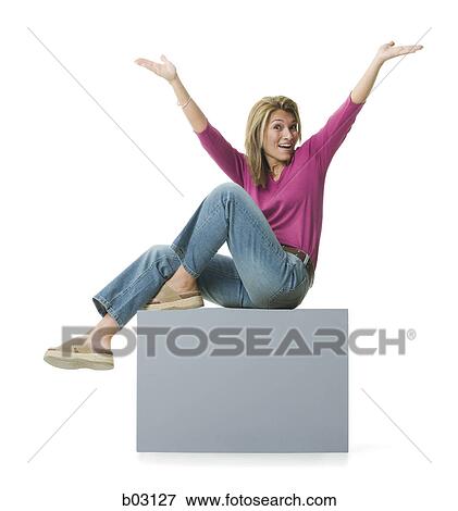 Portrait of a mid adult woman sitting with her arms raised View Large Photo Image Stock Photo - Portrait of a mid adult woman sitting with her arms raised. Fotosearch