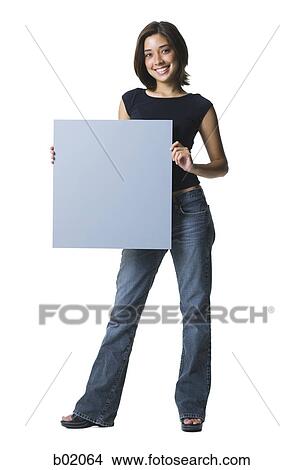 Portrait of a young woman holding a blank sign View Large Photo Image Picture - Portrait of a young woman holding a blank sign. Fotosearch