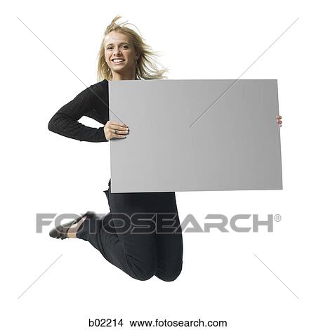 Portrait of a young woman holding a blank sign View Large Photo Image Picture - Portrait of a young woman holding a blank sign. Fotosearch