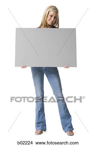 Portrait of a young woman holding a blank sign View Large Photo Image Picture - Portrait of a young woman holding a blank sign. Fotosearch