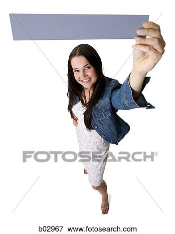 Portrait of a young woman holding a blank sign View Large Photo Image Stock Photo - Portrait of a young woman holding a blank sign. Fotosearch