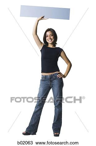 Portrait of a young woman holding up a blank sign View Large Photo Image Stock Image - Portrait of a young woman holding up a blank sign. Fotosearch
