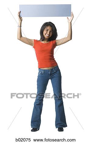 Portrait of a young woman holding up a blank sign View Large Photo Image Stock Photography - Portrait of a young woman holding up a blank sign. Fotosearch
