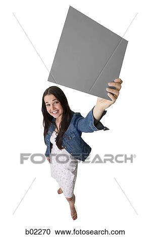 Young woman holding a blank sign View Large Photo Image Stock Image - Young woman holding a blank sign. Fotosearch