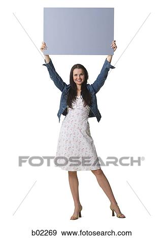 Young woman holding a blank sign View Large Photo Image Stock Photo - Young woman holding a blank sign. Fotosearch