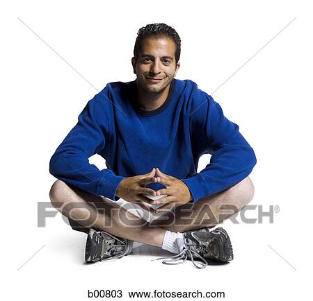 Portrait of a young man sitting with his legs crossed View Large Photo Image Stock Image - Portrait of a young man sitting with his legs crossed. Fotosearch