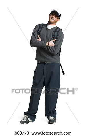 Portrait of a young man standing with his arms folded View Large Photo Image Stock Image - Portrait of a young man standing with his arms folded. Fotosearch